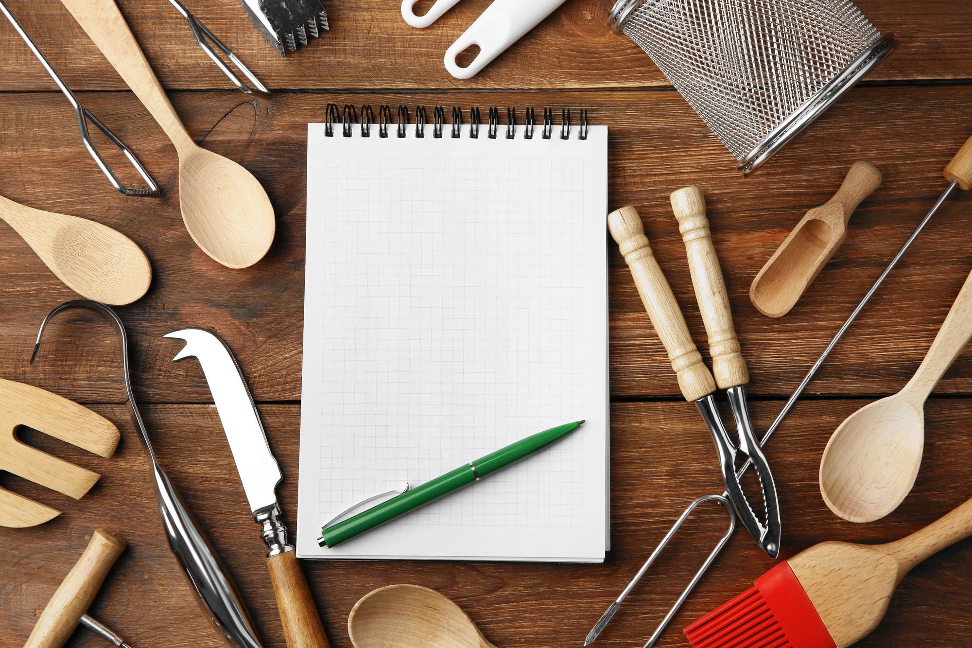 stack of planning notes and kitchen tools